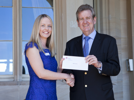 Elena Gray receives her scholarship from Premier Barry O