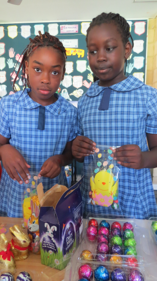 Emmanuela and Dorothy preparing the Easter packages