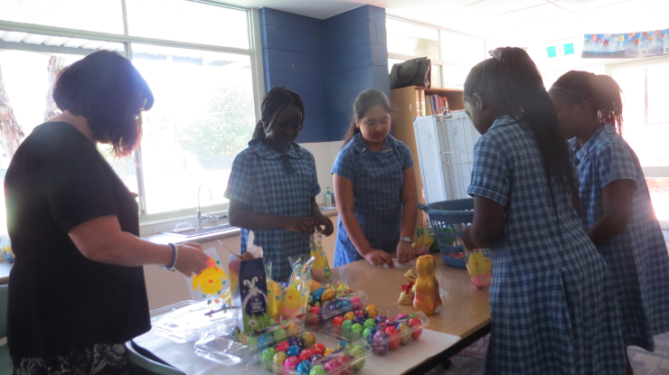 Student teacher, Linda Cartright, with students Aboul, Audrey, Emmanuela and Dorothy bagging the eggs