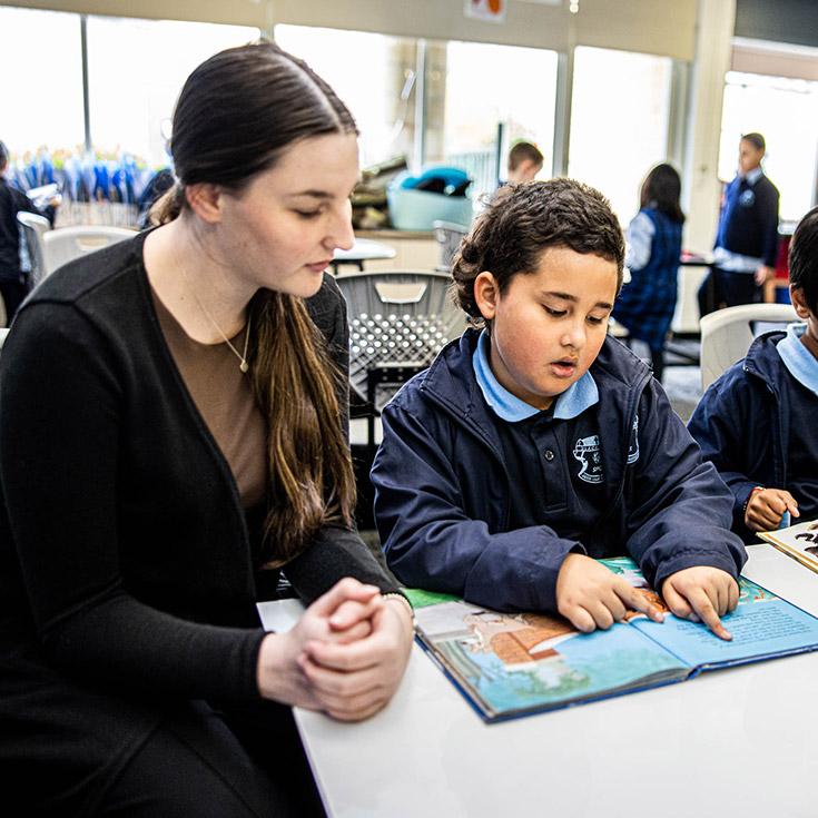Teacher helping student at St Patrick's Catholic Primary Blacktown